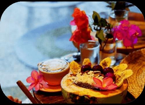 Tropical smoothie bowl served in a papaya with cappuccino at Helio Capitano