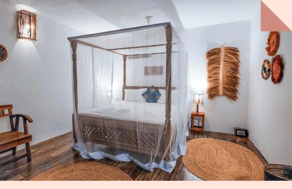 Garden-view junior suite with a four-poster bed and balcony