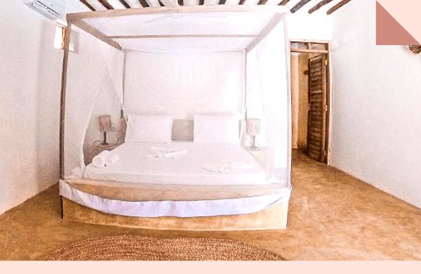 Pool-view bungalow with a four-poster bed and patio