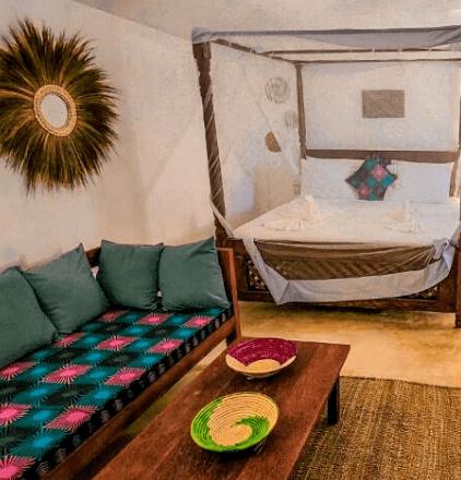 Sea-view double room suite with carved bed and Zanzibari textiles
